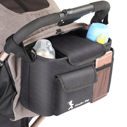 Stroller organizer with storage pockets and a cup holder attached to a stroller.