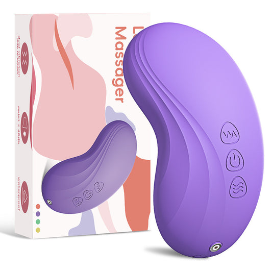 Purple massage device with control buttons next to its packaging on a white background