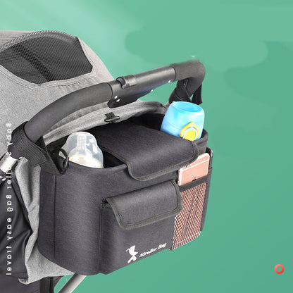 Stroller organizer with cup holder and pockets on a green background